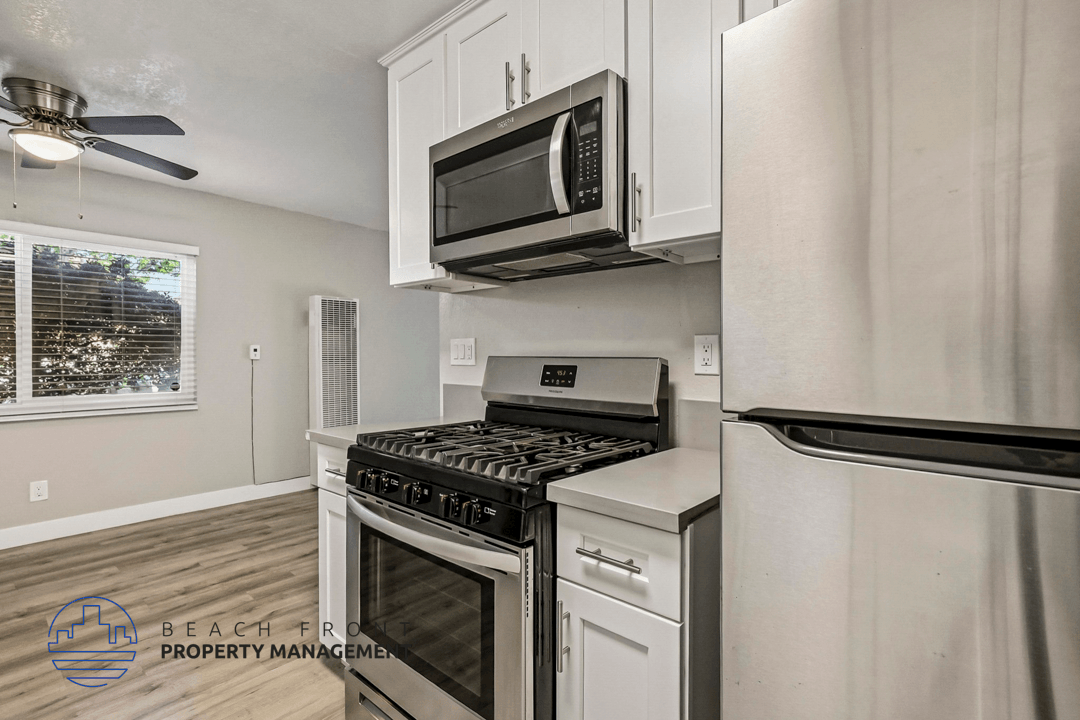 A kitchen with a stove top oven and a microwave above it.